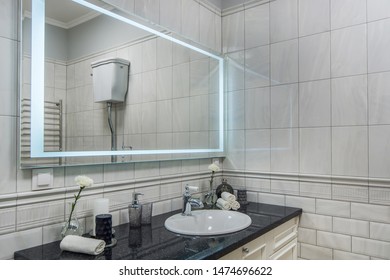 Modern Bathroom With Bathroom Vanity, Sink And Large Backlit Illuminated Mirror