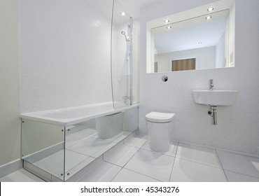 Modern Bathroom In White With Bath Tub And Shower Attachment