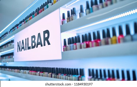 Modern Beauty Salon Interior. Nail Bar. Nail Polishes Of Different Colors On Shelves.