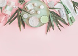 Modern beauty and skin care. Various natural cosmetic products with bamboo branches and aloe vera leaves. Eco friendly body care and spa accessories on pastel pink background. Zero waste . Top view, a Beauty & Fashion Photo by VICUSCHKA