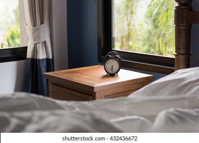 Modern Bedroom With Alarm Clock On Side Table 