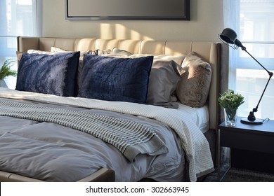 modern bedroom with blue pillows and black lamp on table - Powered by Shutterstock