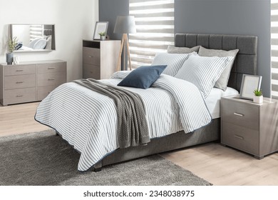 Modern bedroom featuring a bedding duvet cover set, with a gray bed and linen, a white soft comforter set complements the interior