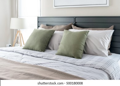 Modern Bedroom With Green Pillows On Bed