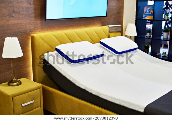 Modern beds\
with mattresses and pillows in the\
store