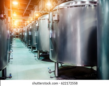 Modern Beer Factory. Rows of steel tanks for beer fermentation and maturation. Spot light effect - Shutterstock ID 622172558