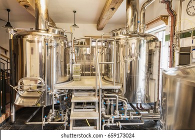 Modern beer plant (brewery), with brewing kettles, vessels, tubs and pipes made of stainless steel. Small home brewery. - Powered by Shutterstock