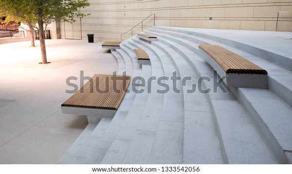 Modern benches and\
concrete stairway in the city square on a sunny day,Public spaces\
in city park