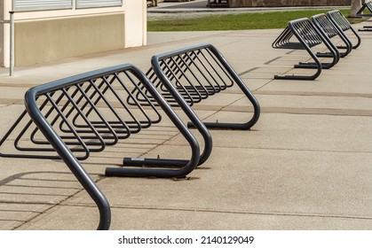 Modern bicycle rack on the street of a city. Nobody, selective focus, street photo - Shutterstock ID 2140129049