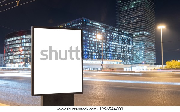 Modern billboard with a blank white screen on a\
busy highway with traffic, neon lights. Empty billboard for\
advertising. Moscow,\
Russia