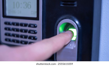 Modern biometric fingerprint scanner with glowing green sensor for secure access, used in advanced security systems, enhancing data protection and workplace safety. - Powered by Shutterstock