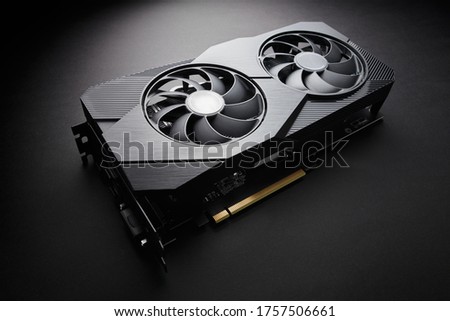 modern black computer video card on a black background, deep shadows and contrasting light, one object close view, electronic device or computer part