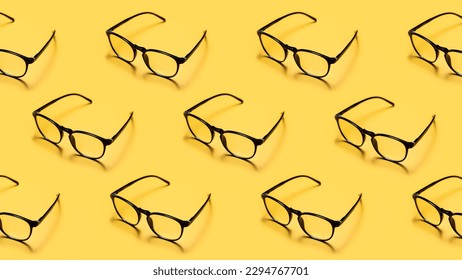 Modern black framed reading glasses or spectacles repeated on a bright yellow background with minimalist style.