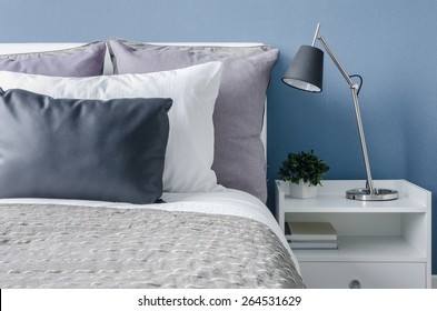 Modern Black Lamp On White Table In Modern Bedroom With Blue Wall