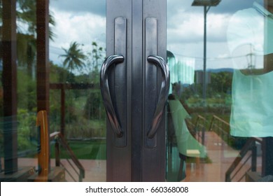 Modern Black Metal Door Handle On Glass Door