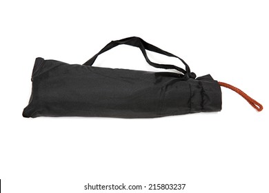 Modern black umbrella folded in cover isolated on white background. - Shutterstock ID 215803237