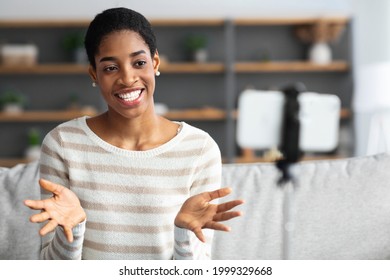 Modern Bloger. Black Female Influencer Recording Video For Her Vlog At Home, Smiling Young African American Woman Using Smartphone On Tripod, Talking And Gesturing At Camera, Closeup Shot - Powered by Shutterstock