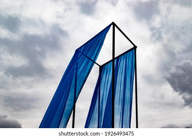 Modern Blue Art Installation, Frame With Curtain Against Sky