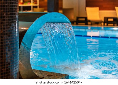 Modern blue on light backdrop. Water - swimming pool. Blue luxurious swimming pool. Swimming pool for luxury lifestyle design. Water - swimming pool. Luxury lifestyle. Natural pattern, luxury. Blue