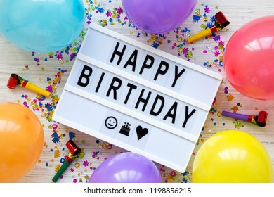 Modern board with text "Happy Birthday", decoration party on white wooden surface, top view. Flat lay, overhead, from above.  - Shutterstock ID 1198856215
