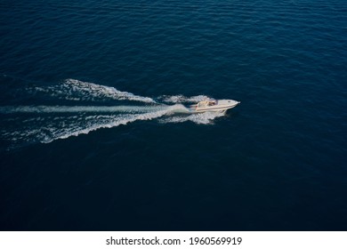Modern Boat With The Flag Of Germany On Turquoise Water. Large Speed Boat Moving At High Speed Side View.  