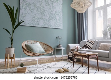 Modern And Bohemian Composition Of Interior Design With Gray Sofa, Rattan Armchair, Retro Footrest, Plaid, Pillow, Tropical Plants, Small Table And Elegant Accessories. Stylish Home Decor. Template.