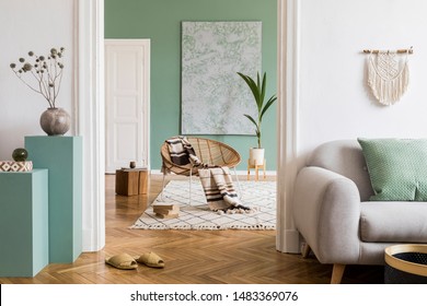 Modern And Bohemian Composition Of Interior Design At Apartment With Gray Sofa, Rattan Armchair, Wooden Cubes, Plaid, Tropical Plant, Macrame And Elegant Accessories. Stylish Home Decor. Template.