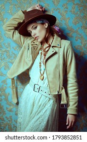 Modern bohemian style. Portrait of a beautiful young woman with elegant natural make-up, beads and clothes in boho style. 