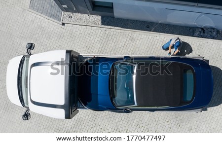 Modern Brand New Convertible Car on Towing Truck Delivered to Client Home. Aerial View. Transportation and Car Sales Theme.
