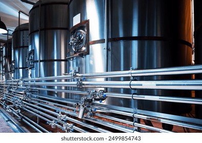 Modern brewery steel tanks and intricate piping, precision and quality in craft beer production - Powered by Shutterstock