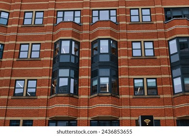 Modern brick building facade with patterned windows and architectural details in Leeds, UK.