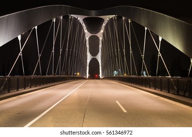 Modern Bridge Over The River Main, Lit By Lamps At Night, Design, Movement, Front View.  Frankfurt Am Main . Germany.