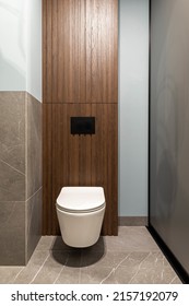 Modern Bright Bathroom With White Toilet Seat On Wooden Lamela Wall. Mirror On Grey Wall. 