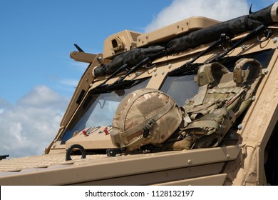 Modern British Military Scout Vehicle With Soldiers Helmet.