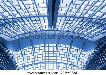 Modern building abstract background pattern. Contemporary symmetrical parasol structure, transparent metal roof. Large construction, forum canopy. Blue colored.