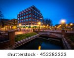 Modern building and bridge over Carroll Creek at night, at Carroll Creek Linear Park, in Frederick, Maryland.