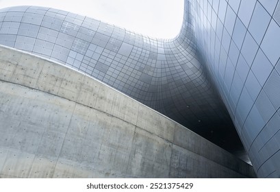 Modern building with a concrete and metal exterior showing a unique and futuristic architectural design - Powered by Shutterstock