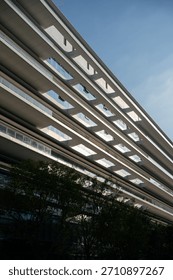 A modern building with a distinctive geometric pattern on its exterior, showcasing contemporary architectural design.