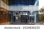  Modern Building Entrance with Glass Facade and Prominent Signage