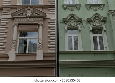 A modern building featuring a green facade is situated right next to another building that boasts a contrasting brown facade beside it - Powered by Shutterstock