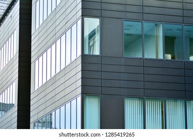 Modern building with reflected sky and cloud in glass window
