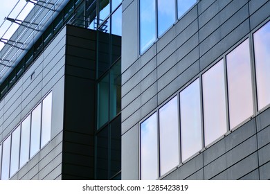 Modern building with reflected sky and cloud in glass window