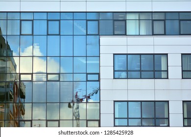 Modern building with reflected sky and cloud in glass window