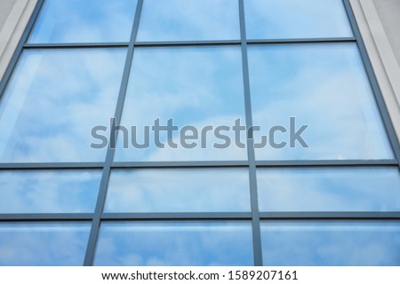 Modern building with tinted windows, low angle view. Urban architecture