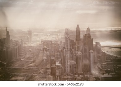 Modern buildings of Downtown Dubai with Sheikh Zayed road against the sun, aerial view.