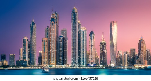 Modern buildings with gold reflection of sunset on Dubai Marina bay view from Palm Jumeirah, UAE. - Powered by Shutterstock