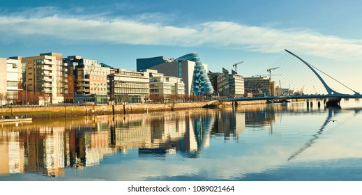 Modern buildings and offices on Liffey river in Dublin on a bright sunny day