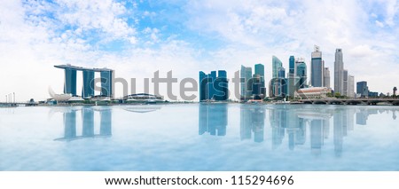 Modern buildings of Singapore skyline landscape in business district  with blue sky and reflection in water of Marina Bay