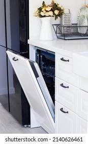 Modern Built-in Dishwasher In Beautiful White Kitchen With Flowers. Beautiful Interior . No People High Quality Photo