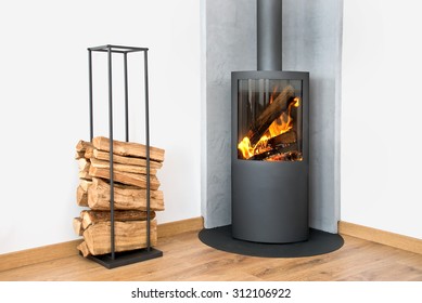 Modern burning stove next to a wood logs rack